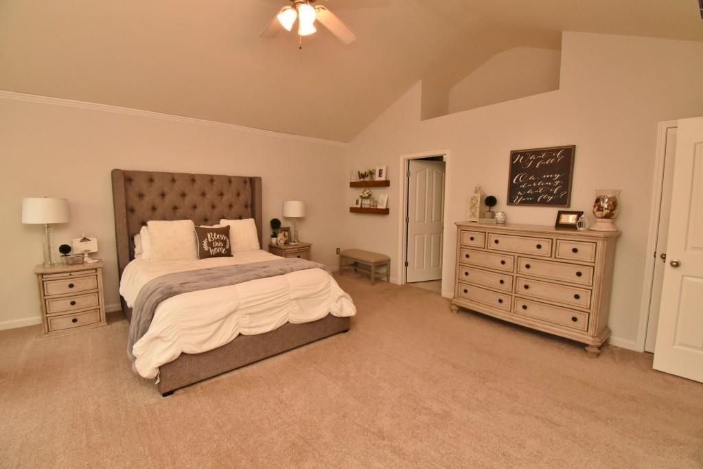 5691 Apple Grove Road Northeast Buford, GA 30519 - Photo 19 of 23 a spacious bedroom with a bed and a cabinets