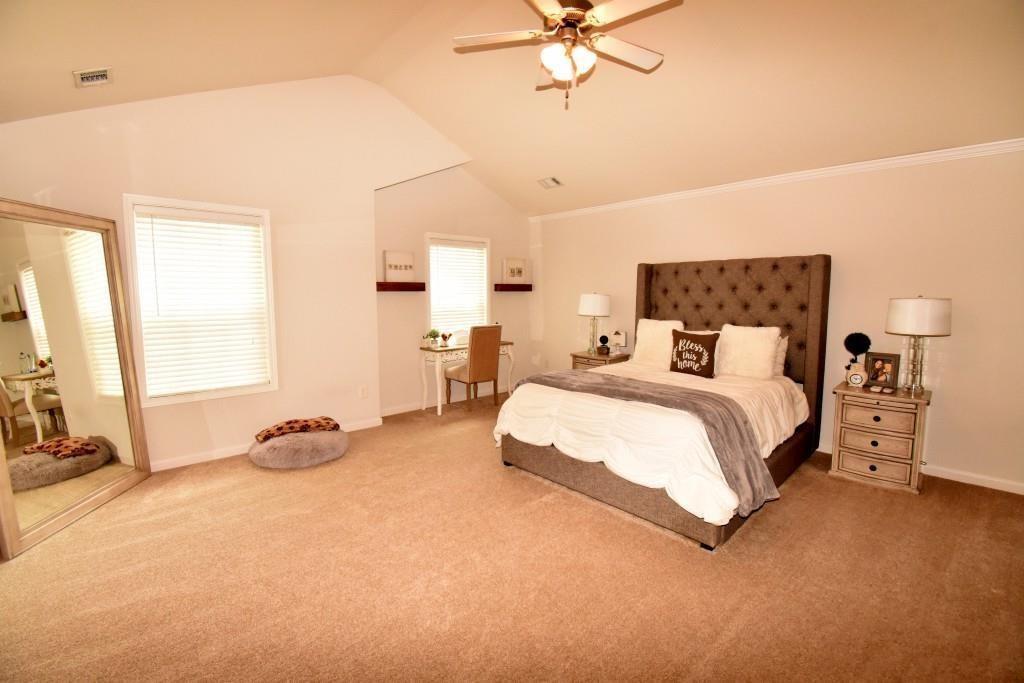 5691 Apple Grove Road Northeast Buford, GA 30519 - Photo 20 of 23 a bed room with a bed and a chandelier