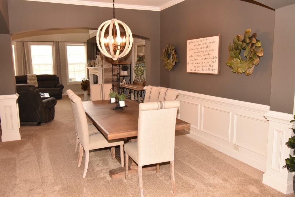 5691 Apple Grove Road Northeast Buford, GA 30519 - Photo 8 of 23 a view of a dining room with furniture and a chandelier