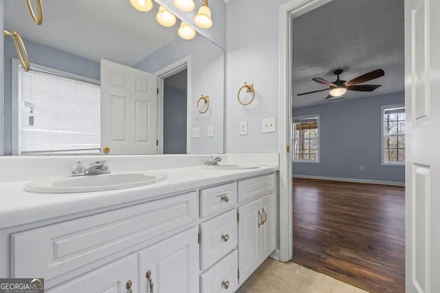 a bathroom with a double vanity sink and a mirror