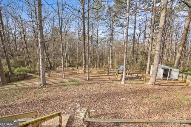 a backyard of a house with barbeque oven