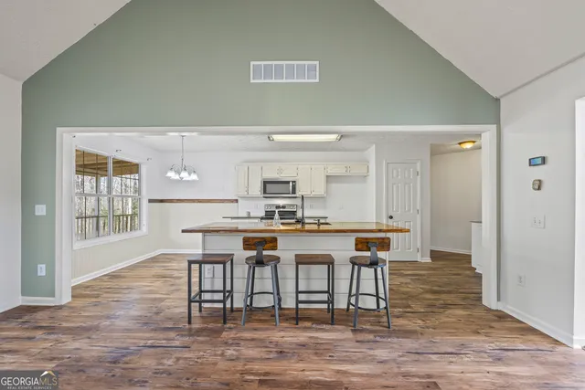 a view of a dining room with furniture and wooden floor