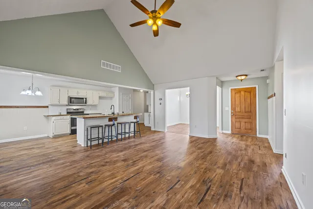 a view of a kitchen with wooden floor and a sink