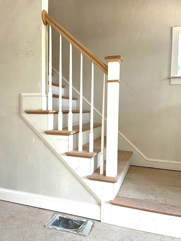 485 Main Street Millis, MA 02054 - Photo 5 of 31 a view of staircase with white walls and a window