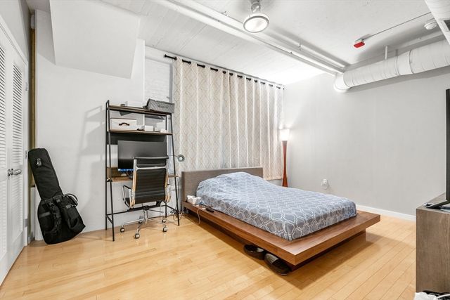 a bedroom with bed and a chair