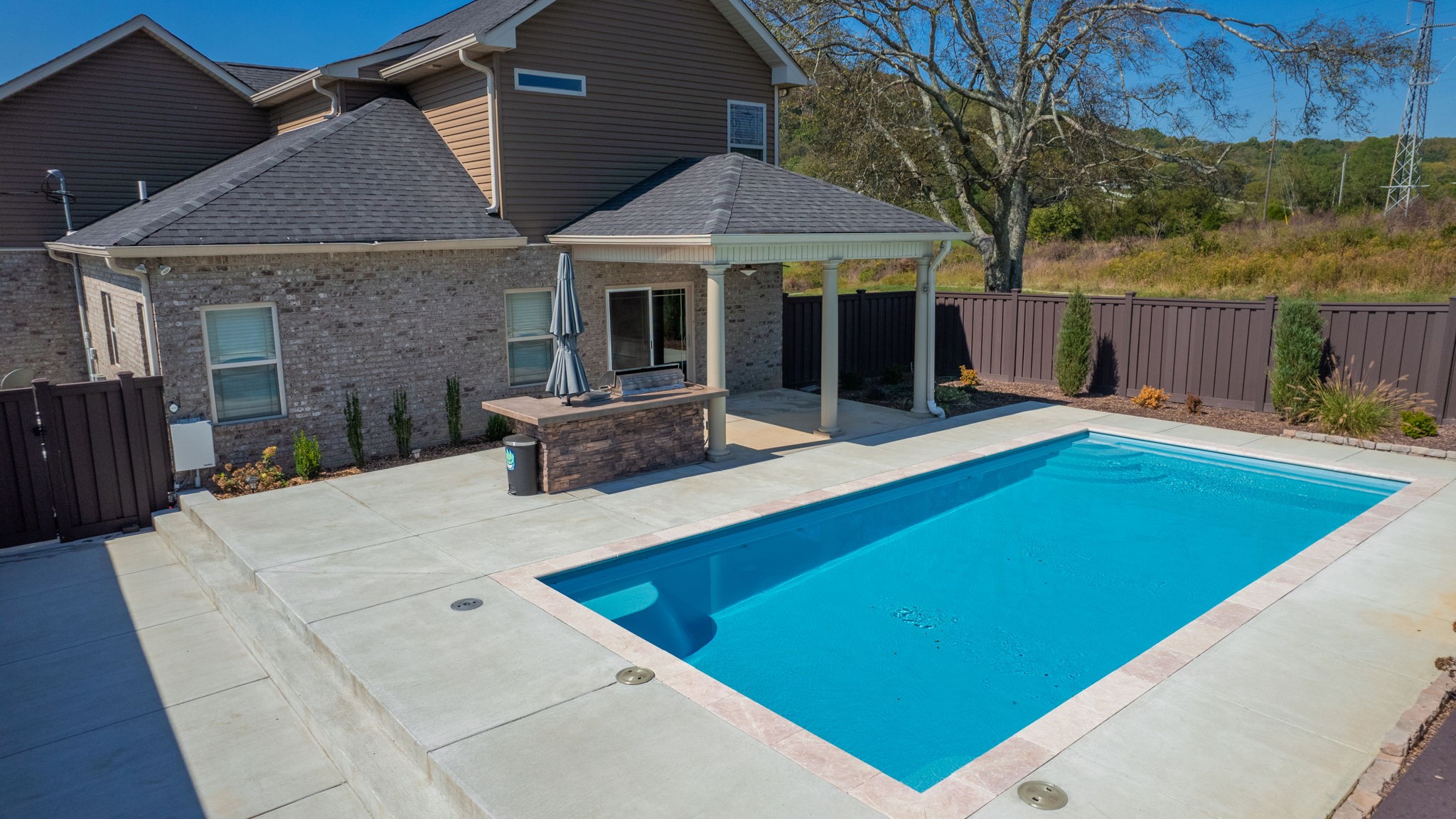 2155 Turner Road Watertown, TN 37184 - Photo 44 of 49 a patio with a table and chairs under an umbrella