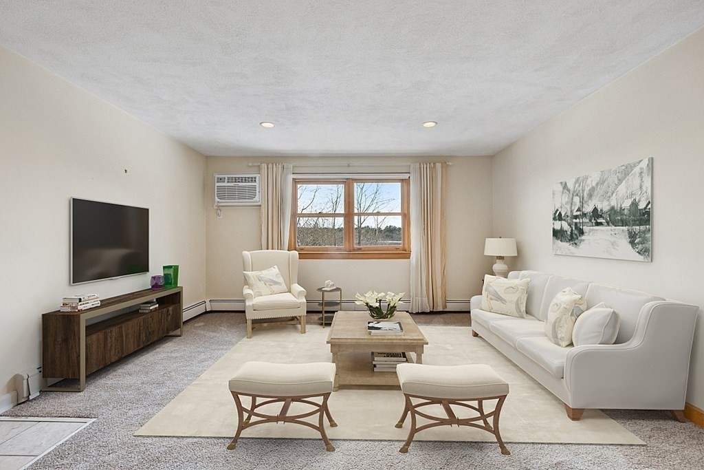 205 Great Road, Unit C1 Acton, MA 01720 - Photo 1 of 18 a living room with furniture and a flat screen tv