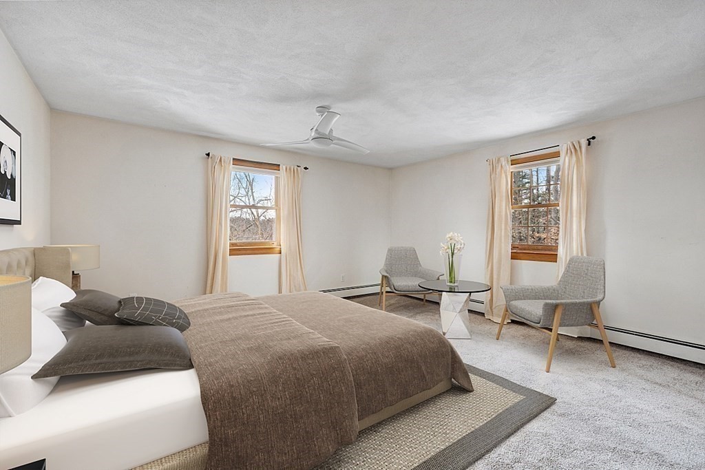 205 Great Road, Unit C1 Acton, MA 01720 - Photo 11 of 18 a bedroom with a bed a table and chair