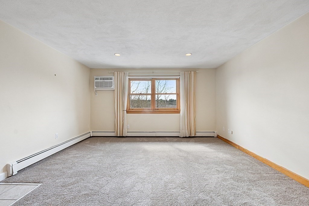 205 Great Road, Unit C1 Acton, MA 01720 - Photo 5 of 18 a view of an empty room with a window