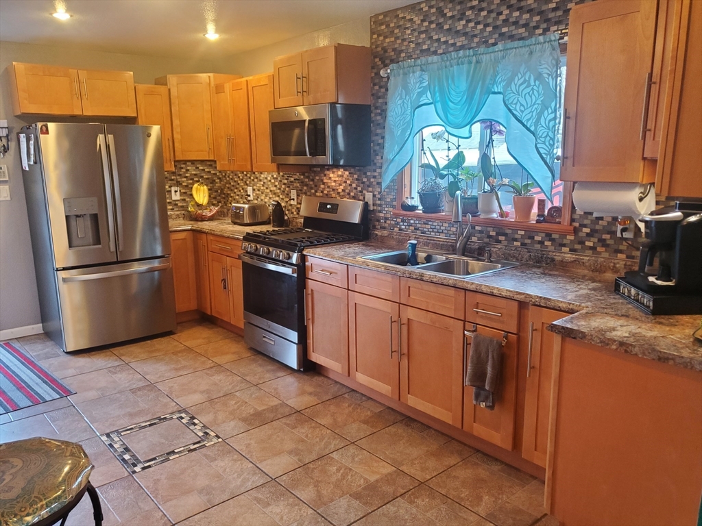 147 Denver Street Springfield, MA 01109 - Photo 3 of 18 a kitchen with stainless steel appliances granite countertop a sink stove and refrigerator