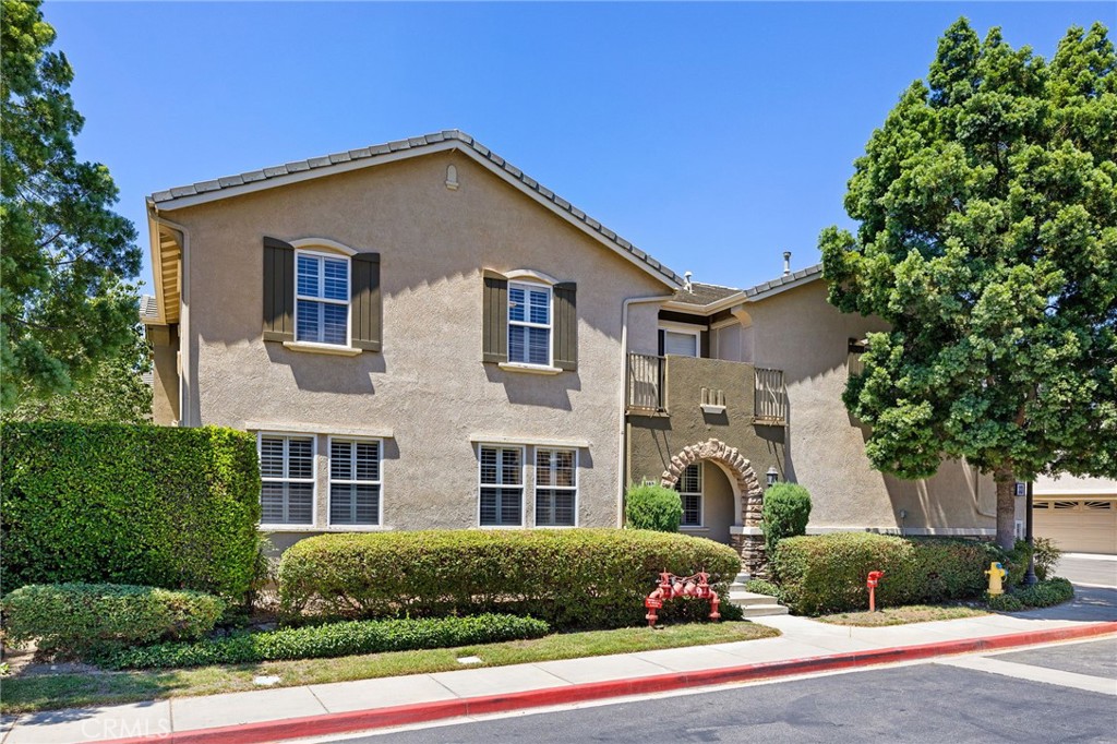 7353 Ellena West, Unit 198 Rancho Cucamonga, CA 91730 - Photo 1 of 1 a front view of a house with a yard