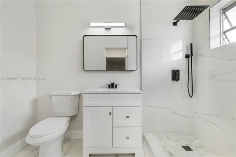 a bathroom with a toilet sink and shower