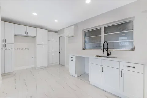 a room with a sink and a large mirror