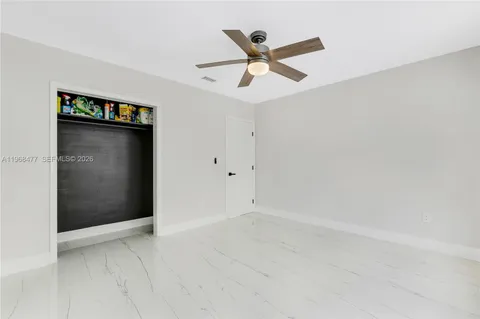 an empty room with closet and windows