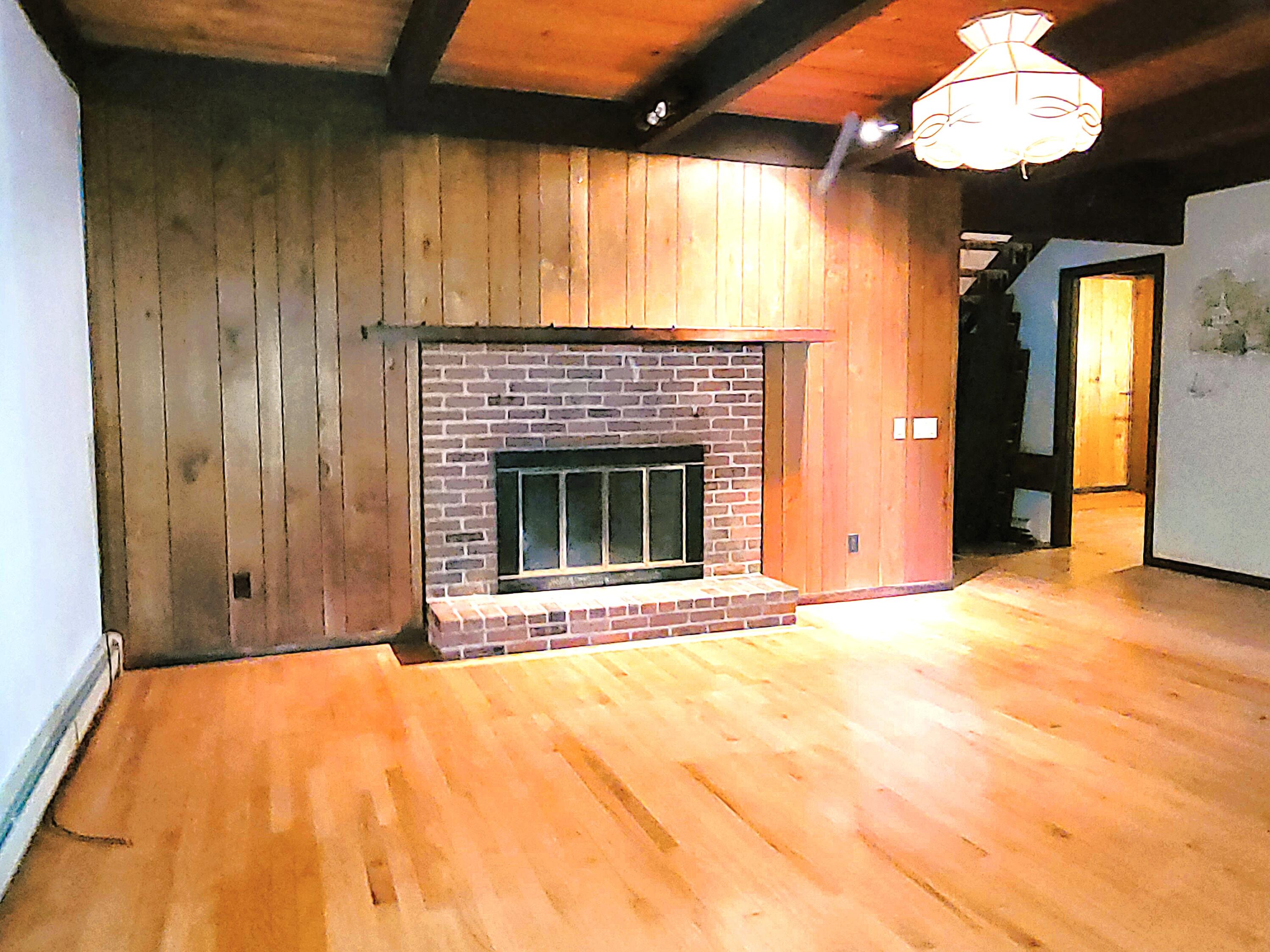 277 Lund Farm Way Brewster, MA 02631 - Photo 25 of 56 a view of an empty room with a fireplace and a window
