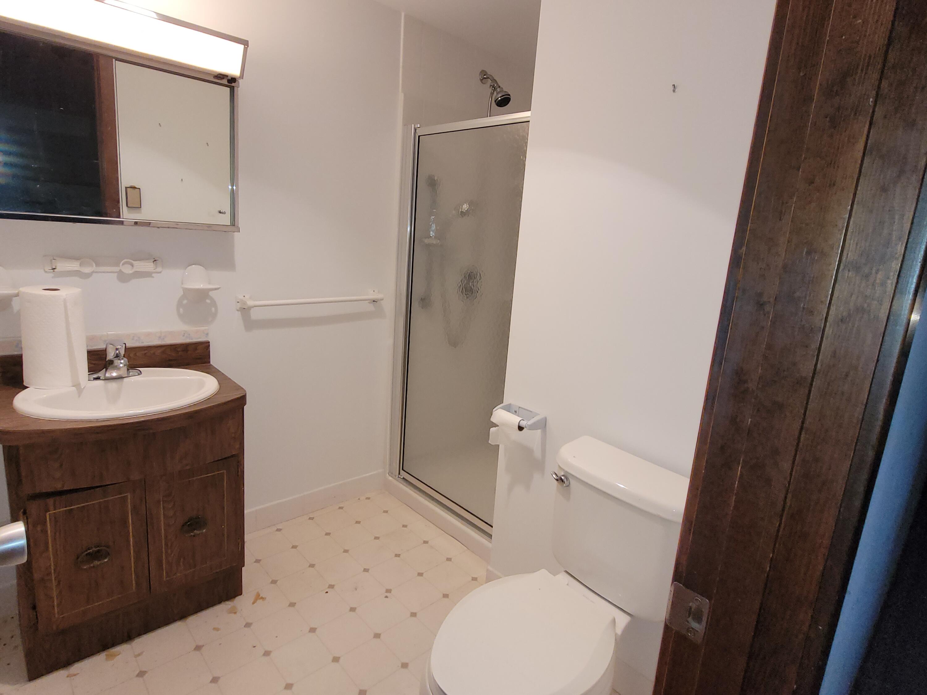 277 Lund Farm Way Brewster, MA 02631 - Photo 38 of 56 a bathroom with a sink a toilet a mirror and shower