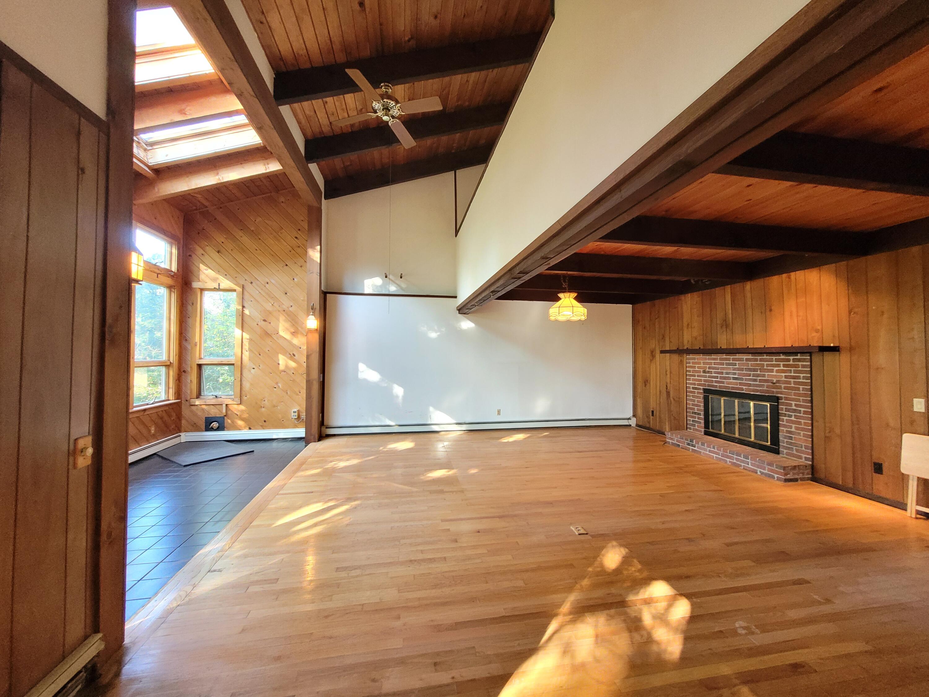 277 Lund Farm Way Brewster, MA 02631 - Photo 5 of 56 a view of an empty room with a fireplace and a window