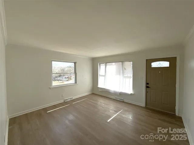 an empty room with a empty space and windows