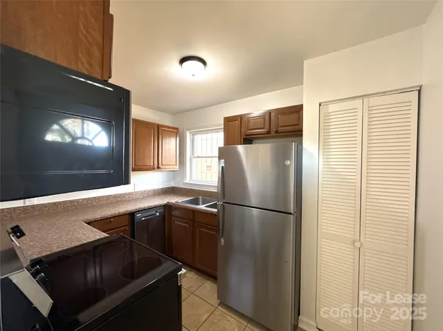 a kitchen with a refrigerator and a sink