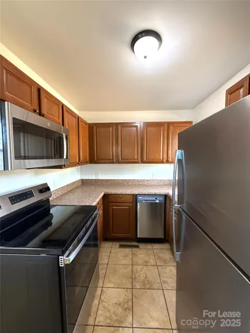a kitchen with a refrigerator and a sink