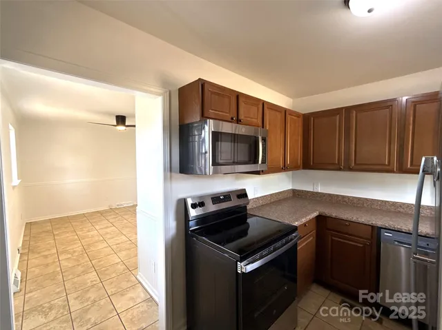a kitchen with a sink and a stove top oven