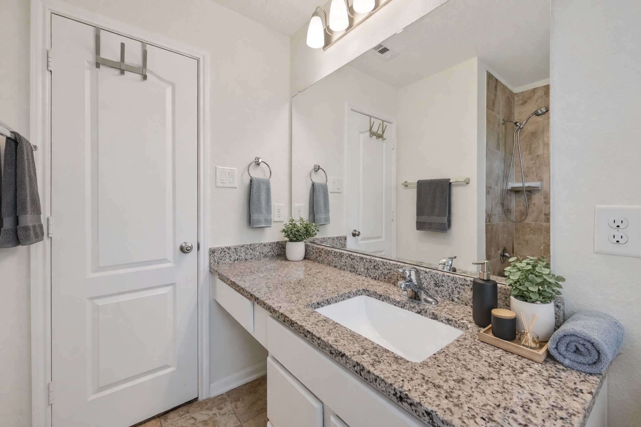 2107 Parnevik Place Conroe, TX 77304 - Photo 33 of 44 and a single sink with a vanity makeup area. digitally enhanced