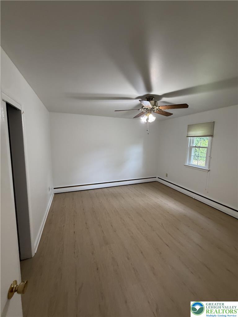 5391 Chapmans Road, Unit 2 Orefield, PA 18069 - Photo 15 of 22 An inviting room boasts natural light, a ceiling fan, and sleek vinyl flooring.