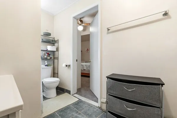 a bathroom with a toilet and a shower