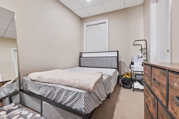 a bedroom with bed and window