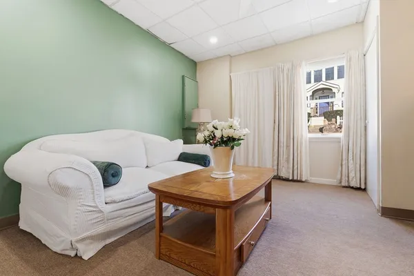 a living room with furniture and flowers