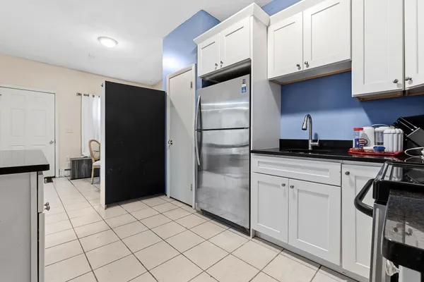 a kitchen with stainless steel appliances a refrigerator and cabinets