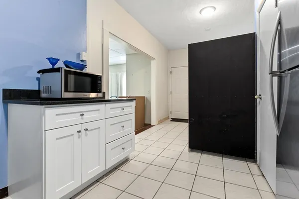 a kitchen with a refrigerator and a sink