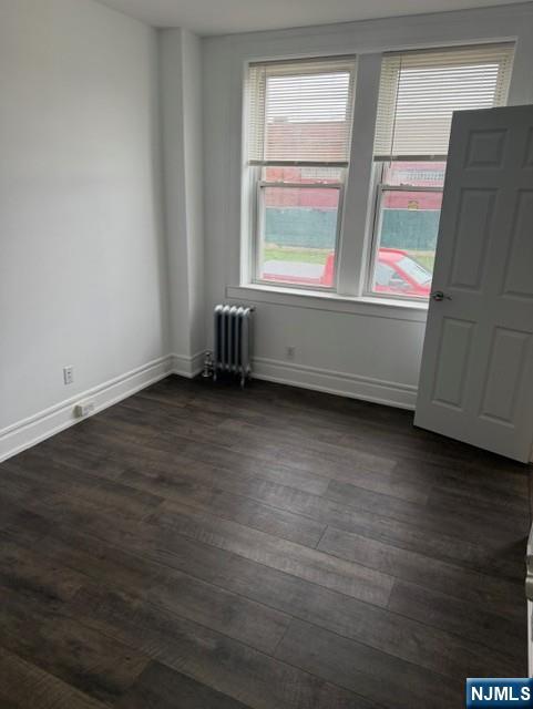 48 Hancox Avenue Nutley, NJ 07110 - Photo 11 of 15 an empty room with wooden floor and windows
