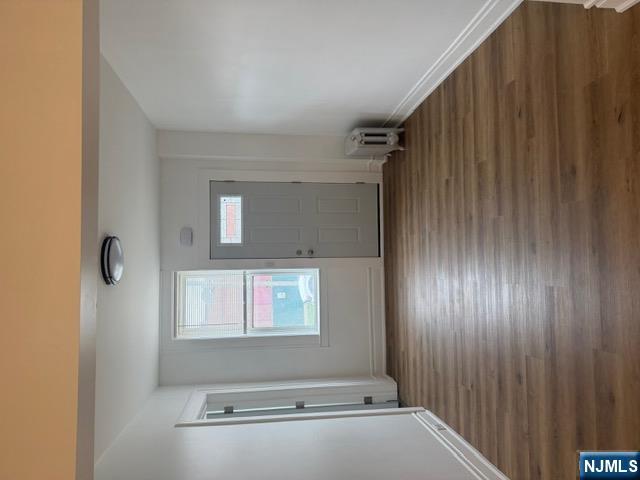 48 Hancox Avenue Nutley, NJ 07110 - Photo 2 of 15 an empty room with wooden floor and windows
