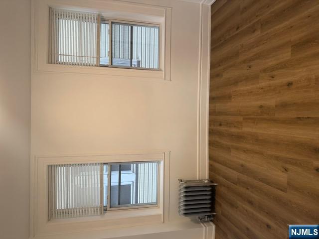 48 Hancox Avenue Nutley, NJ 07110 - Photo 4 of 15 a view of an empty room with wooden floor and a window