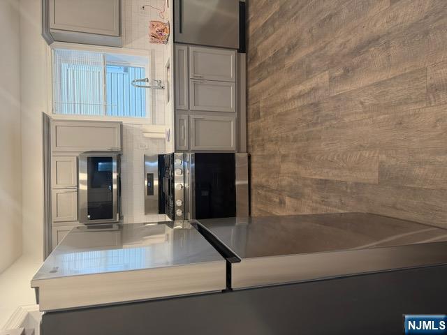 48 Hancox Avenue Nutley, NJ 07110 - Photo 5 of 15 a kitchen with stainless steel appliances a refrigerator a sink a stove a microwave and cabinets