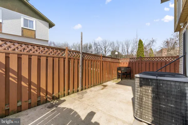 a view of a roof deck with wooden fence