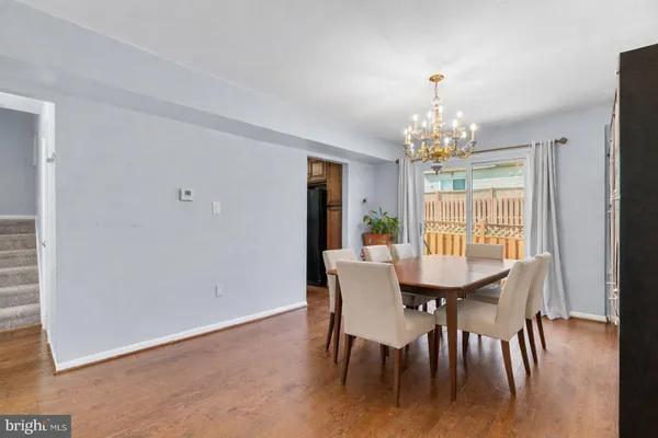 a view of a dining room with furniture wooden floor and chandelier