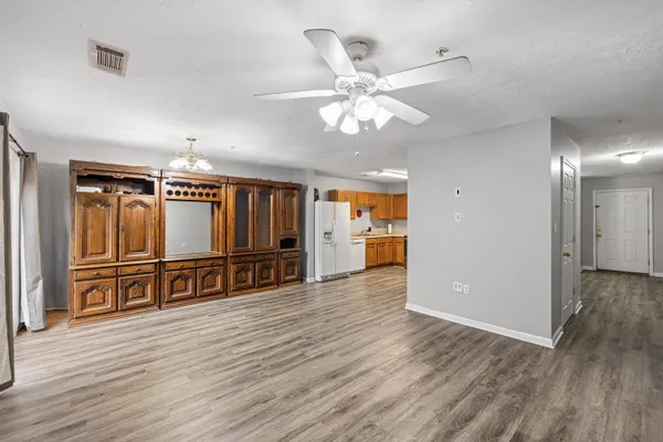 a view of a room with wooden floor