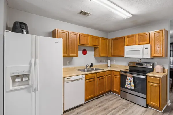 a kitchen with stainless steel appliances a sink stove and refrigerator