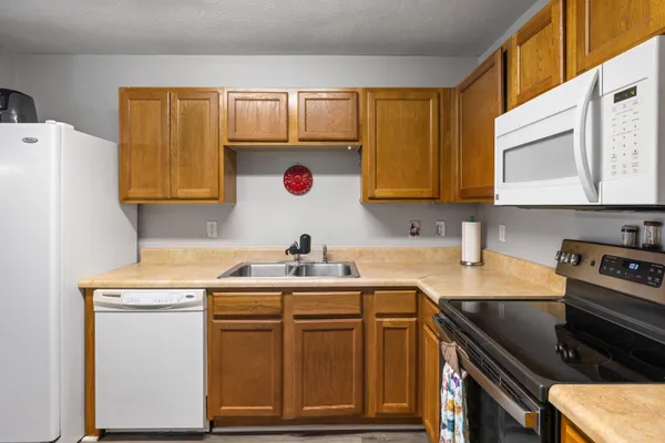 a kitchen with a sink stove and cabinets