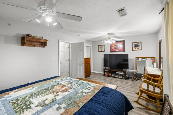 a bedroom with bed and a flat screen tv