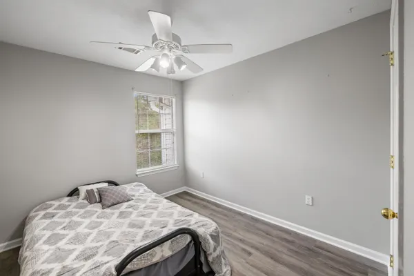 a bedroom with a bed and a chandelier