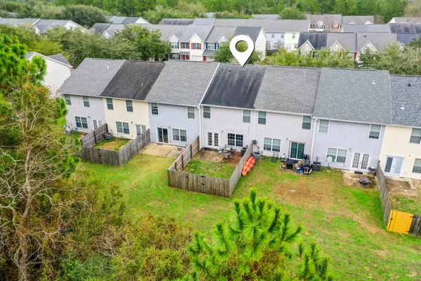 an aerial view of a house with swimming pool garden and patio