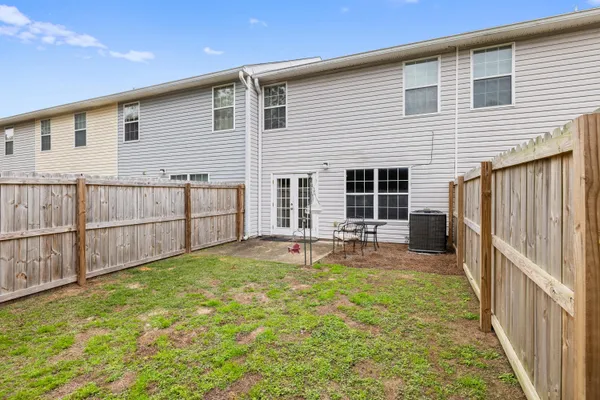 a view of a house with backyard and sitting area