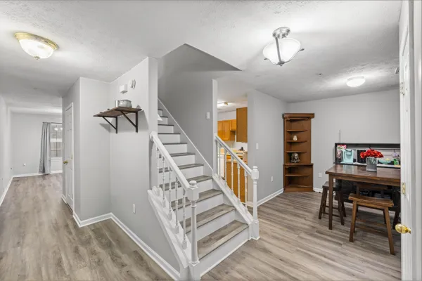 a view of entryway and hall with wooden floor