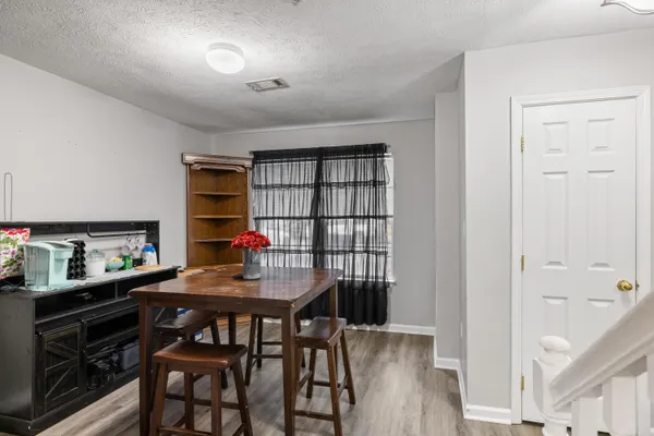 a dining room with furniture and window