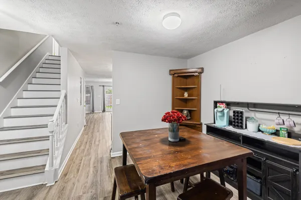 a view of a dining room with furniture and wooden floor