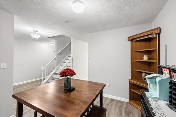a view of a dining room with furniture and wooden floor