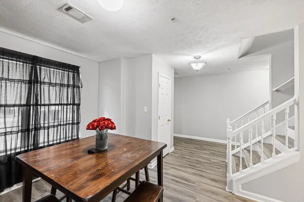 a view of a room with furniture and wooden floor